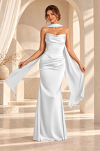 Front view of the white strapless draped floor-length evening gown