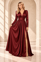 Burgundy A-line evening gown shown with the skirt gently held to display its folds and front slit.