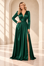 Emerald green long-sleeve V-neck gown with a ruched waistband and front slit, front view.
