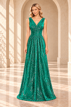 Front view of an emerald green sequin evening gown with a crossover V-neck, ruched waist, and floor-length A-line skirt.