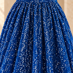 Close-up of royal blue sequins and vertical folds on the skirt of the MX340 evening gown.