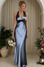 Front view of the Dusty Blue halter V-neck evening gown with a crossed ruched waist and softly flared column skirt.