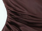 Close-up of ruching at the chocolate brown gown waist