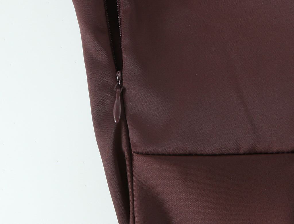 Close-up of a zipper and seam on the chocolate brown gown
