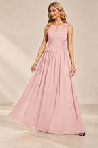 Model wearing the blush pink keyhole neck pleated A-line evening gown, front view.