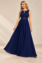 Model wearing the navy blue keyhole neck pleated A-line evening gown, front view.