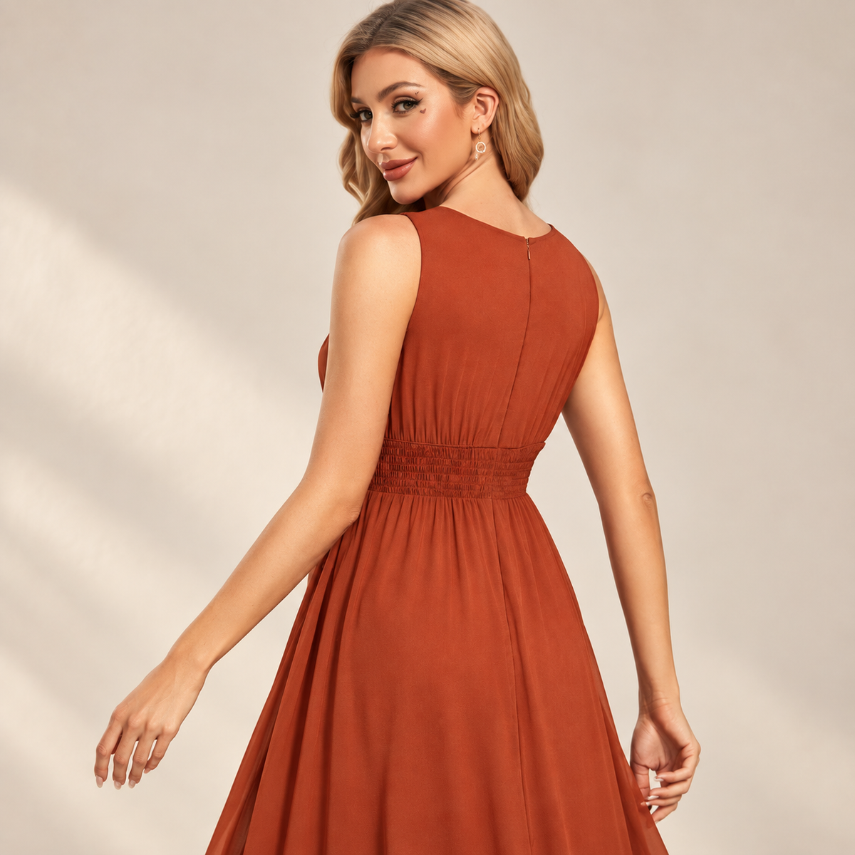 Back view of the rust orange keyhole neck pleated A-line evening gown.
