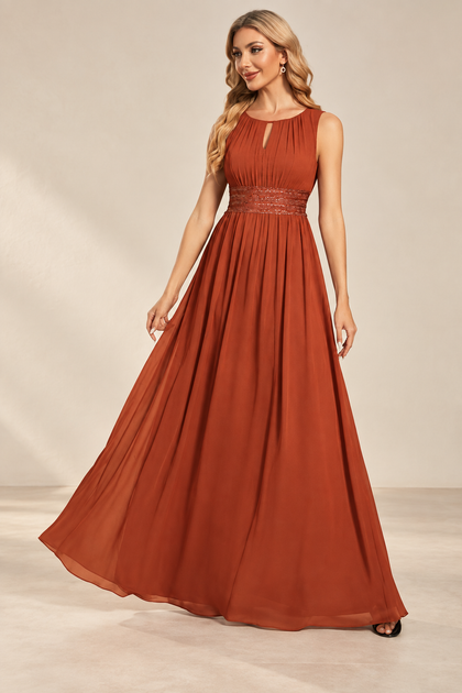 Model wearing the rust orange keyhole neck pleated A-line evening gown, front view.