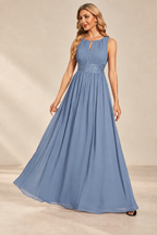 Model wearing the slate blue keyhole neck pleated A-line evening gown, front view.