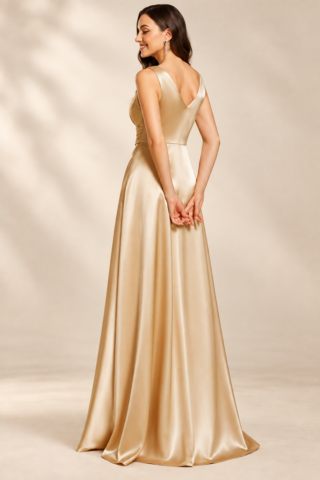 Rear three-quarter view of the champagne gown showing its V-shaped back and A-line skirt
