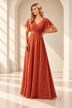Burnt orange A-line evening gown with a pleated crossover V-neck, flutter sleeves and a floor-length skirt.