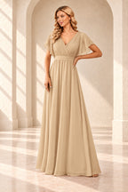 Champagne A-line evening gown with a pleated crossover V-neck, flutter sleeves and a floor-length skirt.
