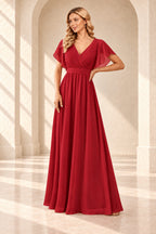 Red A-line evening gown with a pleated crossover V-neck, flutter sleeves and a floor-length skirt.